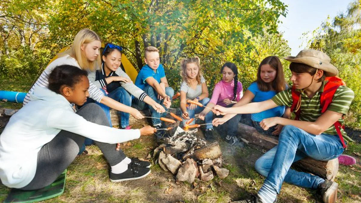 Des enfants autour d&rsquo;un feu de camp lors d&rsquo;une colonie de vacances