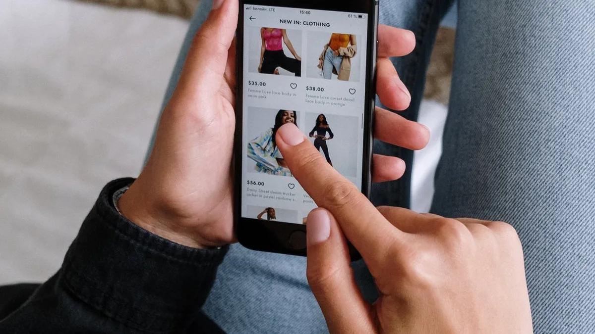 Une personne consulte des annonces de vêtements d&rsquo;occasion sur son téléphone